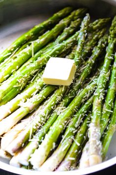 asparagus with butter and parmesan cheese in a pan