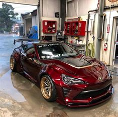 a red sports car parked in a garage