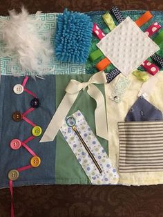 several different items are laid out on a table top, including buttons and ribbon ties