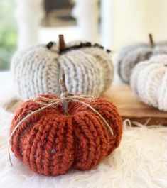 three knitted pumpkins sitting on top of a table