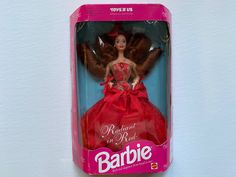 the barbie doll is wearing a red dress