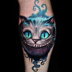 a close up of a person's leg with a cat on it and blue eyes