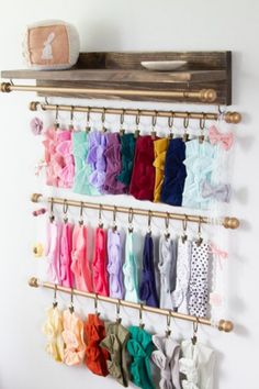 there is a rack that has many different types of bow ties on it and hanging from the wall