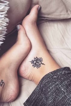 a woman's foot with a small tattoo on it