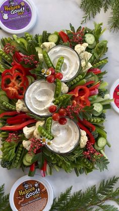 an arrangement of vegetables and dips on a table