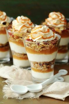 small desserts with whipped cream and toppings in glass dishes on a tablecloth