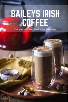 two glasses of coffee sitting on top of a wooden tray