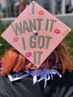 a person wearing a pink graduation cap with the words i want it i got it written on it