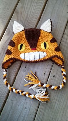 a crocheted hat with an orange and white cat face on top of it