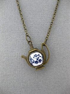 Forget Me Not Teapot Necklace OVERVIEW: This Necklace can be used with a lot of different themes in mind. If you are leaning towards a fairytale vibe, like Alice In Wonderland, then yes this will work for you. It also provides a simply charming vibe. And it is great for Tea Lovers. If you just love flowers, maybe Blue flowers, then maybe you'll fancy this necklace for that reason. But our absolute favorite way to think of this necklace, is of course, with the Forget Me Not theme in mind. Forget Alice In Wonderland Necklace, Alice In Wonderland Jewelry, Dragons Breath Fire Opal, Teapot Necklace, Pressed Flower Jewelry, Blue Bell Flowers, Adornment Jewelry, Cottagecore Clothes, Indie Girl