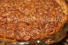 a pie sitting on top of a glass pan in an oven next to a rack