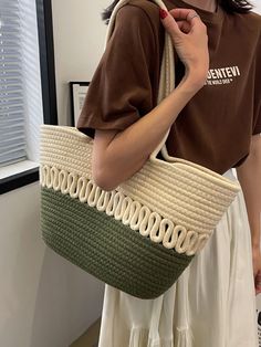 a woman holding a straw bag in her hand