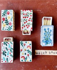 four matchboxes with different designs on them