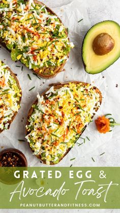 an avocado toast with shredded cheese and other toppings next to sliced avocado