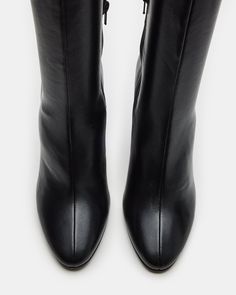 Elevate your style with our ARIA knee-high heeled boot. Crafted with a sleek design, these boots will add a touch of sophistication to any outfit. You can confidently step out in style with a comfortable heel height and secure fit. Perfect for any fashion-forward individual. 4 inch heel height Size 6 measurements: 13.5 inch shaft circumference, 14.5 inch shaft height Size 8 measurements: 14 inch shaft circumference, 15.75 inch shaft height Size 10 measurements: 15 inch shaft circumference, 16.5 Sleek Medium Width High Ankle Boots, Chic High Ankle Wedge Boots With Reinforced Heel, Modern Wide Calf Boots With Reinforced Heel, Trendy Mid-calf High Ankle Boots For Work, Modern High Ankle Heeled Boots With Padded Ankle, Modern High Ankle Mid-calf Boots, Sleek Wide Calf Boots With Reinforced Heel, Sleek Wide Calf Heeled Boots With Reinforced Heel, Sleek Mid-calf High Ankle Boots