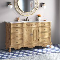 a bathroom with a sink, mirror and rug