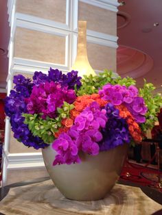 a large vase filled with purple and orange flowers