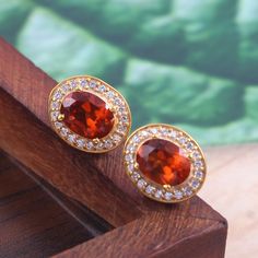 This Sterling Silver Jewelry set features an Elegant Art With Natural Hessonite Gemstone. The cavity is made from genuine solid 925/92.5 Sterling silver with 18k Gold Plating and stamped as S925. This Jewelry is Lead free and Rhodium plated to prevent scratches and tarnish. ITEM DESCRIPTION Item Code: JACBS2/45 Metal: 18k Gold over 925/92.5 Sterling Silver Gemstone: Genuine Natural Hessonite Gemstone Shape: Oval Gemstone Size: 6 X 8 MM Ring Dimension:- Length: 12 MM Width: 11 MM Weight: 3.93 gm Round Gold Gemstones Fine Jewelry, Gold Gemstone Jewelry For Anniversary, Luxury Gold Jewelry With Halo Design, Luxury Gold Halo Design Jewelry, Elegant Citrine Gemstones For Wedding, Elegant Wedding Citrine Gemstones, Gold-plated Yellow Gold Earrings With Gemstone Accents, Oval Gold Gemstones With Accents, Yellow Gold Topaz Earrings, Round Shape