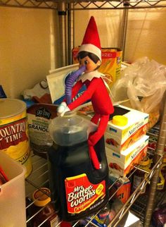 an elf is standing on top of a shelf in the pantry with food and milk