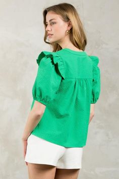 Introducing the Puff Sleeve Textured V-Neck Top in a vibrant green hue. This lightweight blouse features a split neckline and ruffle detail at the shoulder for a touch of playfulness. Its boxy fit makes it easy to tuck into your favorite trousers or pair with flare jeans. Green V-neck Top With Ruffles, Green Cotton V-neck Blouse, Chic Green Puff Sleeve Top, Summer Green Cotton Puff Sleeve Top, Green Cotton Puff Sleeve Top For Summer, Green Puff Sleeve Top For Spring Day Out, Chic Green Puff Sleeve Blouse, Green Puff Sleeve Tops For Spring, Green Puff Sleeve Top With Short Sleeves For Spring