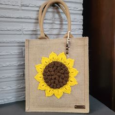 Go Green with this chic and reusable burlap tote bag with statement Sunflower crochet applique! Materials: burlap tote, cotton crochet applique and wood and glass charm accents.  It comes in three sizes: Small, Medium and Large. Please see pictures for measurements.  Buy 2, or more and get a FREE Shipping! Available with other images. Please see the link below: https://www.etsy.com/shop/SnejanaCreations?ref=seller-platform-mcnav&section_id=24729981 Thank you for visiting my shop! Handmade Beige Burlap Bag, Handmade Beige Burlap Bags, Brown Tote Beach Bag Gift, Brown Tote Beach Bag For Gift, Rectangular Jute Bag For Gifts, Casual Jute Bag As Gift, Casual Jute Bags For Gifts, Burlap Tote Gift Bag, Eco-friendly Jute Bag Perfect For Gifts