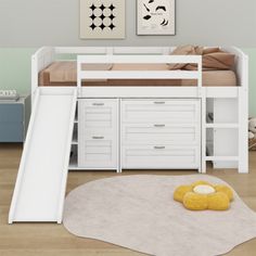 a white bunk bed with slide and drawers