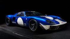 a blue and white sports car parked in the dark