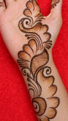 the hand is decorated with an intricate design on it's left arm and wrist