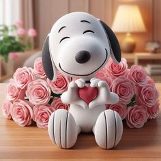 a snoopy dog sitting on top of a table with pink roses in the background