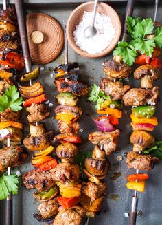 several skewers of meat and vegetables on a tray