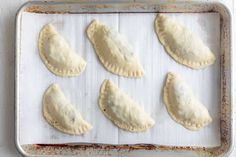 six pastries on a baking sheet ready to go into the oven in the oven