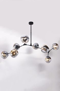 a modern chandelier with eight glass balls hanging from the ceiling