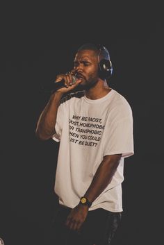 a man with headphones on singing into a microphone