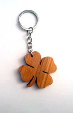 a wooden four leaf clover keychain on a white background