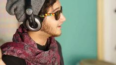 a young man wearing headphones and scarf