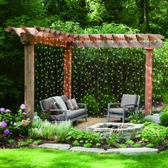 an outdoor living area with couches, chairs and string lights on the pergoline