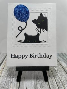 a birthday card with two cats and a blue balloon on the front that says happy birthday