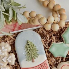 decorated cookies in the shape of christmas trees and snowflakes are on display next to other holiday decorations