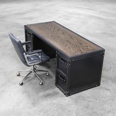 an office desk with a chair next to it on the concrete floor, in front of a gray background