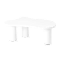 a white table sitting on top of a white floor