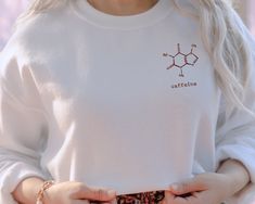 This comfy sweatshirt features a cute Caffeine Molecule  design on the front. Great gift for Coffee lovers. This sweater is also super adorable with the sleeves rolled up! It's the perfect, trendy sweatshirt! SIZING: * Sizing is unisex * Runs true to size * For an oversized look we suggest to size up 1 to 2 sizes PRODUCT DETAILS: * Soft preshrunk 50% cotton, 50% polyester blend * Medium weight fabric (super soft feel) * Wash inside out (on cool for best results) * Made in the USA CARE INSTRUCTIO Cute Crew Neck Sweatshirt For Everyday, Cute Long Sleeve Sweatshirt For Everyday, Cute Crew Neck Sweatshirt For Gift, Cozy Sweatshirt As A Gift, Casual Crew Neck Sweater As Gift, Casual Crew Neck Sweater For Gift, Casual Crew Neck Sweater Ideal For Gifts, Cozy Long Sleeve Sweatshirt For Gift, Casual Sweater With Relaxed Fit As Gift