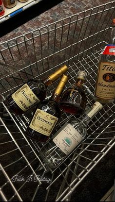 an empty shopping cart filled with liquor bottles