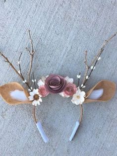 a pair of antlers decorated with flowers and leaves