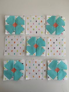 several squares are arranged on the wall with dots and polka dotes in blue, green, white, and orange