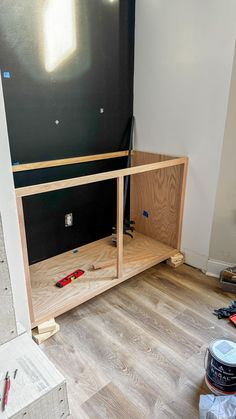 an unfinished entertainment center being built with plywood