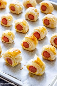 pigs in a blanket are on a baking sheet and ready to go into the oven