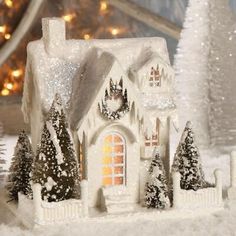 a white christmas house with trees and lights