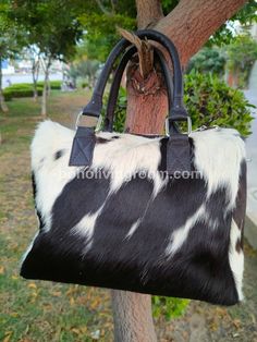 Black & white cowhide shoulder bag for daily use. Embrace western & southern style. Perfect for work, carry your daily essentials. - Free shipping on all our cowhide shoulder bags. - Exotic hair-on-hide material. - Adjustable leather strap for customizable comfort. - Interior features cotton/satin lining with 2 inside pockets and one zipper pocket. - Structured handbag crafted with exquisite craftsmanship. - Measurements: Height: 10 inches X Length: 12 inches X Depth: 6 inches - Please note: Pictures are for illustration purposes only. - Each cowhide purse takes approximately seven business days to complete. This cow skin shoulder bag is skillfully made from high-quality cowhide leather, featuring a captivating combination of black and white hues that exude both sophistication and practica Rectangular Cow Print Travel Bag, Black Calf Hair Shoulder Bag For Everyday Use, Black Calf Hair Rectangular Bag, Cow Print Leather Bag For Daily Use, Black Calf Hair Bags For Everyday Use, Black Calf Hair Bag For Everyday Use, Everyday Black Calf Hair Bag, Black Bag With Cow Print For Everyday Use, Leather Cow Print Bag For Everyday Use