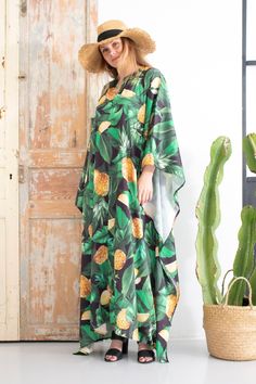 Anakon present this beautiful caftan with tropical print. It is very stylish and comfortable to wear. You can wear it in a way you wish, with bikini or leggings or whatever your imagination offers you. Not transparent. CREATION All our garments are created in our workshop in Barcelona (Spain). We take care of every detail and work hard on production of every kaftan dress. The garments we make are part of the sustainable fashion system since we buy fabric in stocks, we do not order meters of fabr Tropical Green Kaftan For Beach Cover-up, Tropical Dress With Kimono Sleeves, Summer Tropical Style Kaftan With Tropical Print, Summer Tropical Print Kaftan, Tropical Kaftan With Kimono Sleeves For Vacation, Summer Tropical Kaftan With Tropical Print, Tropical Vacation Kaftan With Kimono Sleeves, Tropical Flowy Maxi Kaftan, Flowy Tropical Style Maxi Kaftan