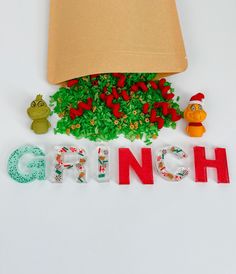 the word grino spelled out in plastic letters next to a lamp shade on a white surface